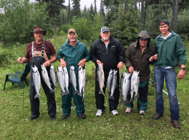 A Group Of Men Holding Fish