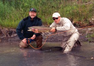 Two Men with a Large Rainbow Trout